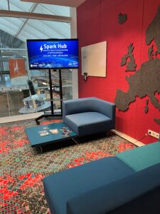 interior of Spark Hub at SBIC Noordwijk showing screen and sofas