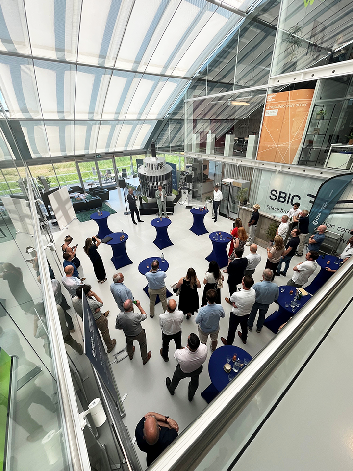 space business professionals by the satellite at SBIC Noordwijk