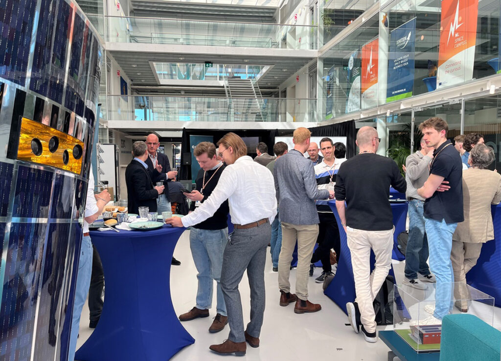 audience of space and non-space business professionals networking by satellite