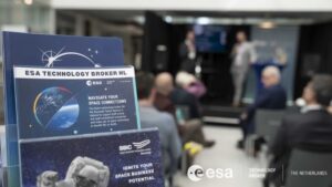 space business professionals presenting on stage with flyers in the foreground