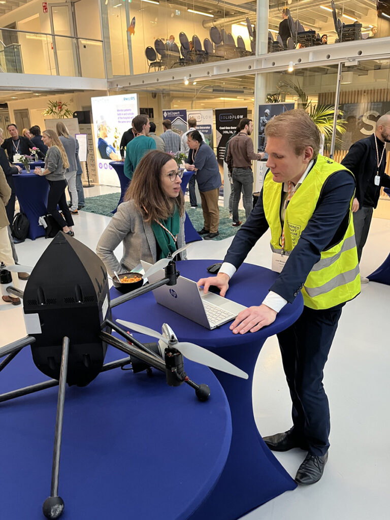 space business professionals by the satellite at SBIC Noordwijk
