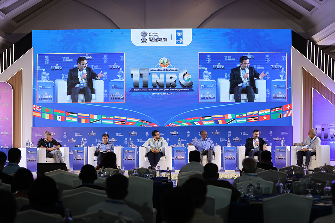 Vikram Sarbajna on stage during panel discussion at conference in India