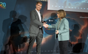 space business professionals on stage awarding trophy
