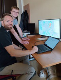 space business professionals at a computer working on algorithms