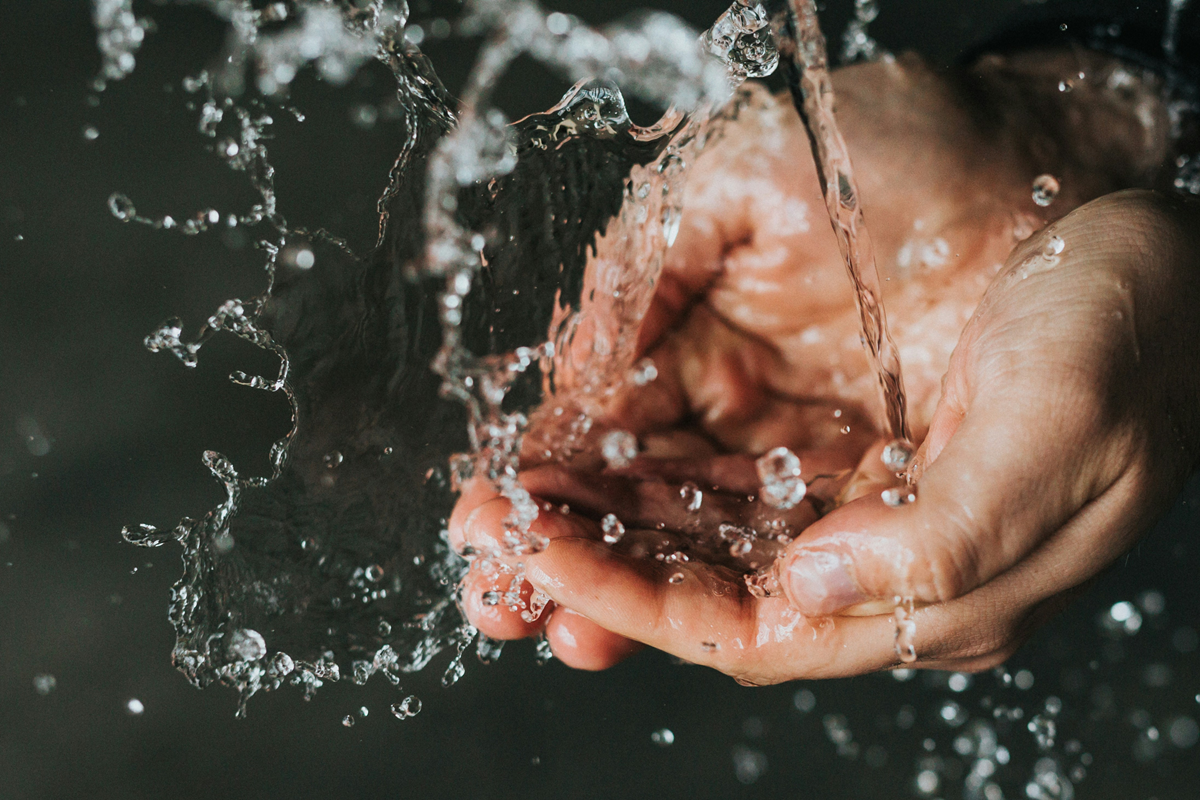 water pouring onto hand