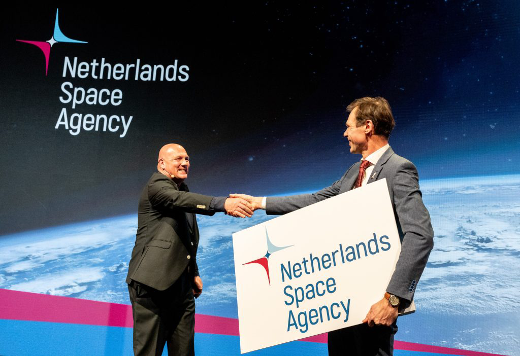 space business professionals on stage at space symposium launching new identity