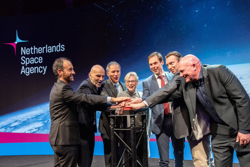 space business professionals on stage at space symposium launching new identity and website