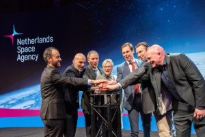 space business professionals on stage at space symposium launching new identity and website
