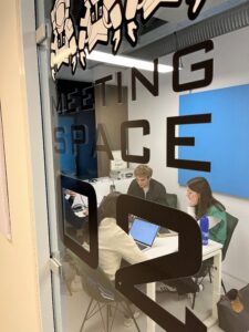 Student delegation sitting in a group at SBIC Noordwijk working on business challenges about the space industry