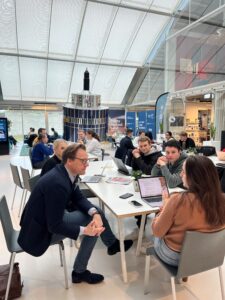Student delegation sitting in a group at SBIC Noordwijk working on business challenges about the space industry