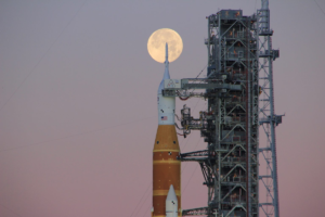 Artemis II rocket on its launchpad with the full Moon in the background