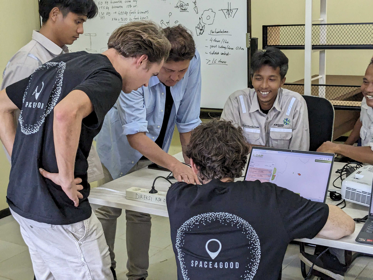 tech professionals with rangers on site in rainforest