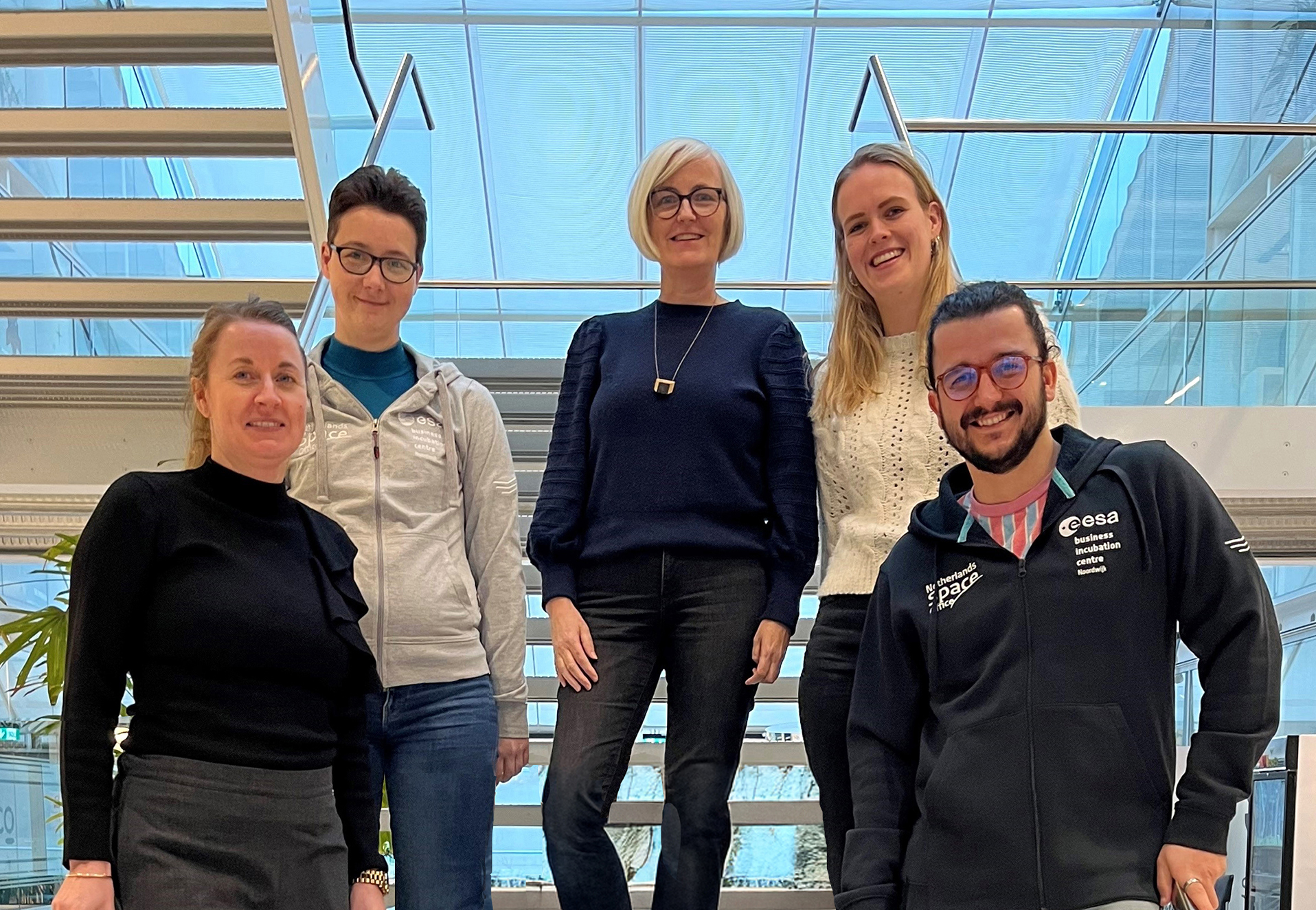 SBIC team members on the stairs in the atrium at SBIC Noordwijk