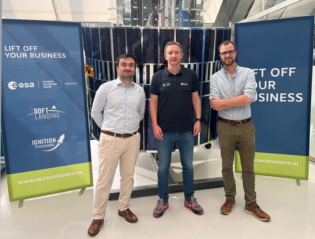 space business professionals by the satellite at SBIC Noordwijk