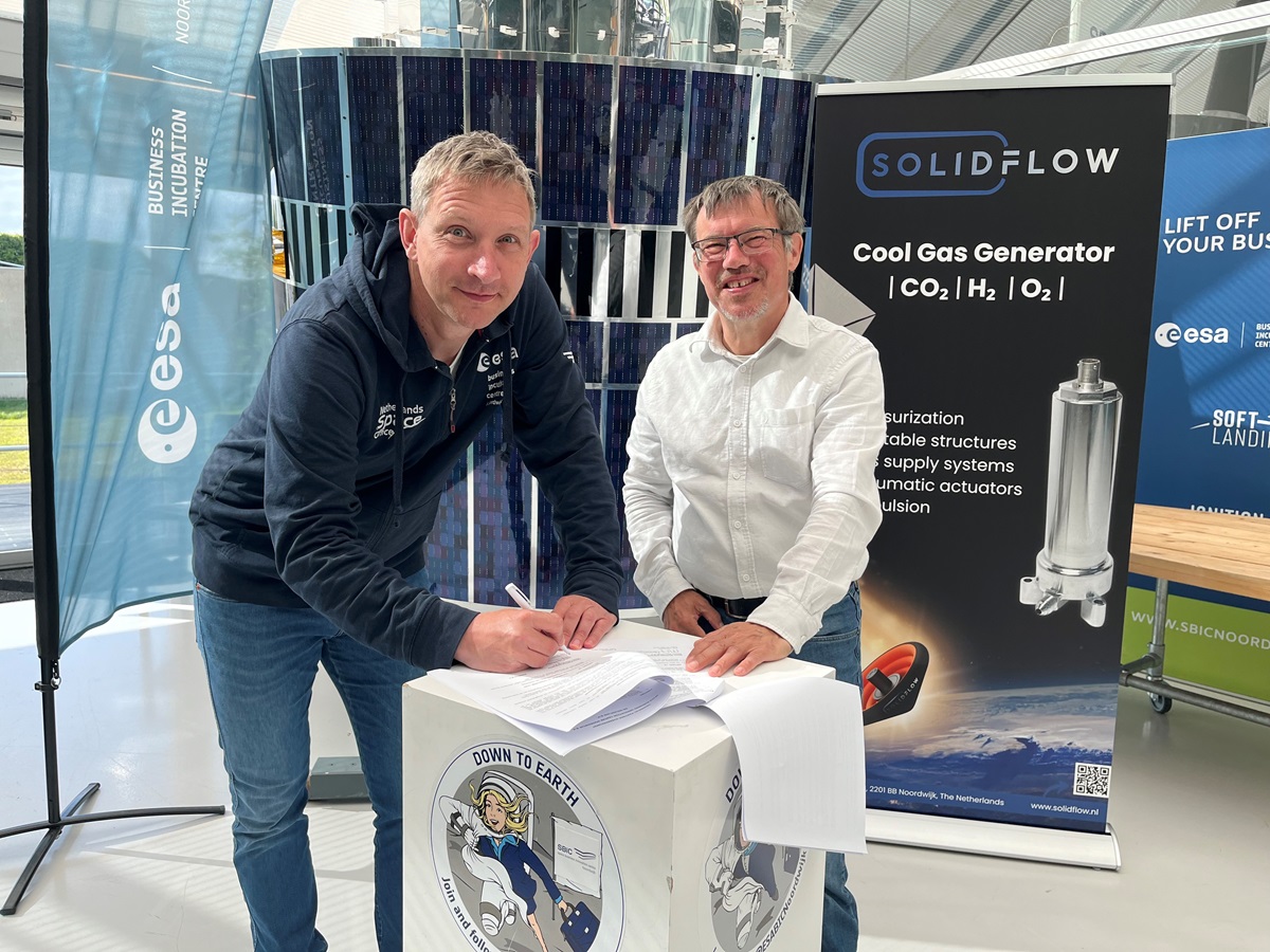 space business professionals stood by the satellite at SBIC Noordwijk