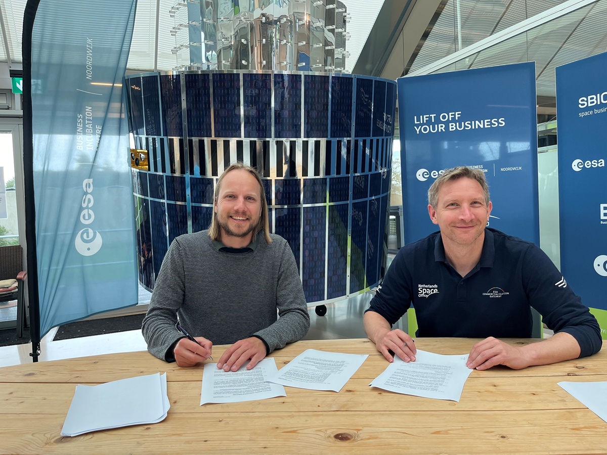 space business professionals by the satellite at SBIC Noordwijk